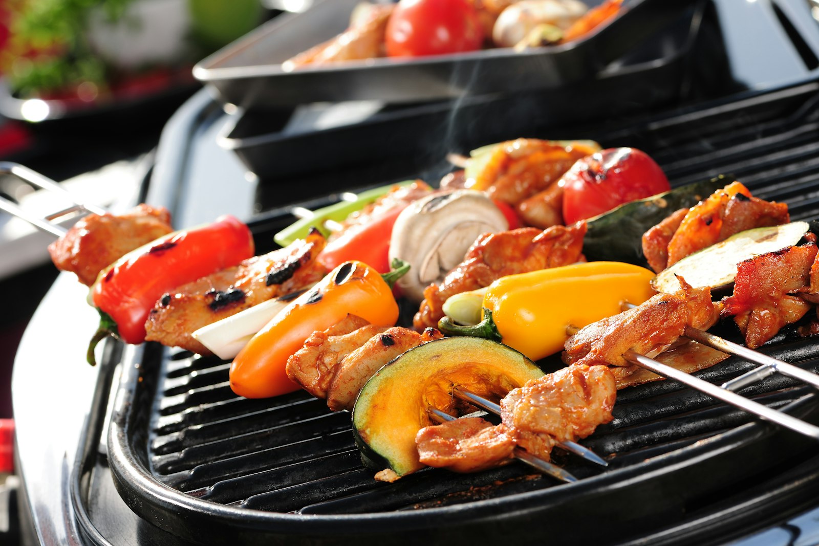 Tabletop grill with vegetable and meat skewers