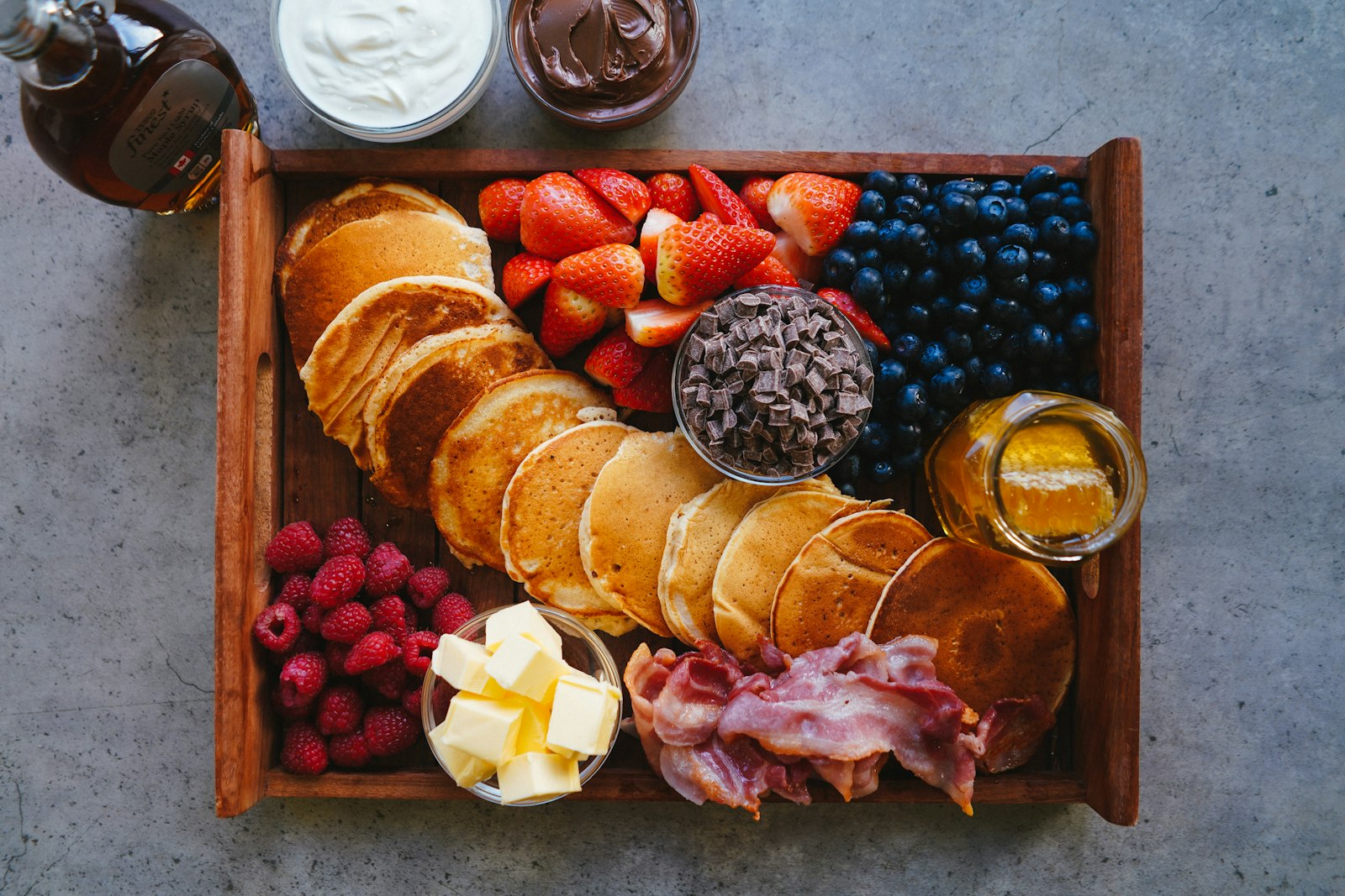 Pancake board with berries, fruit and toppings