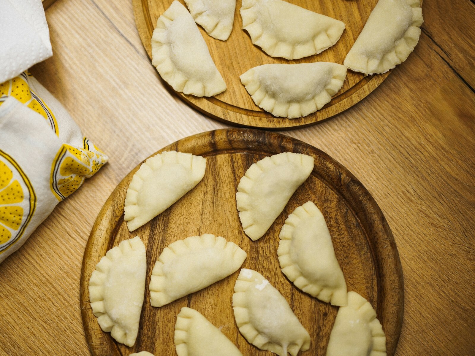 Golden pierogi dumplings on a wooden board