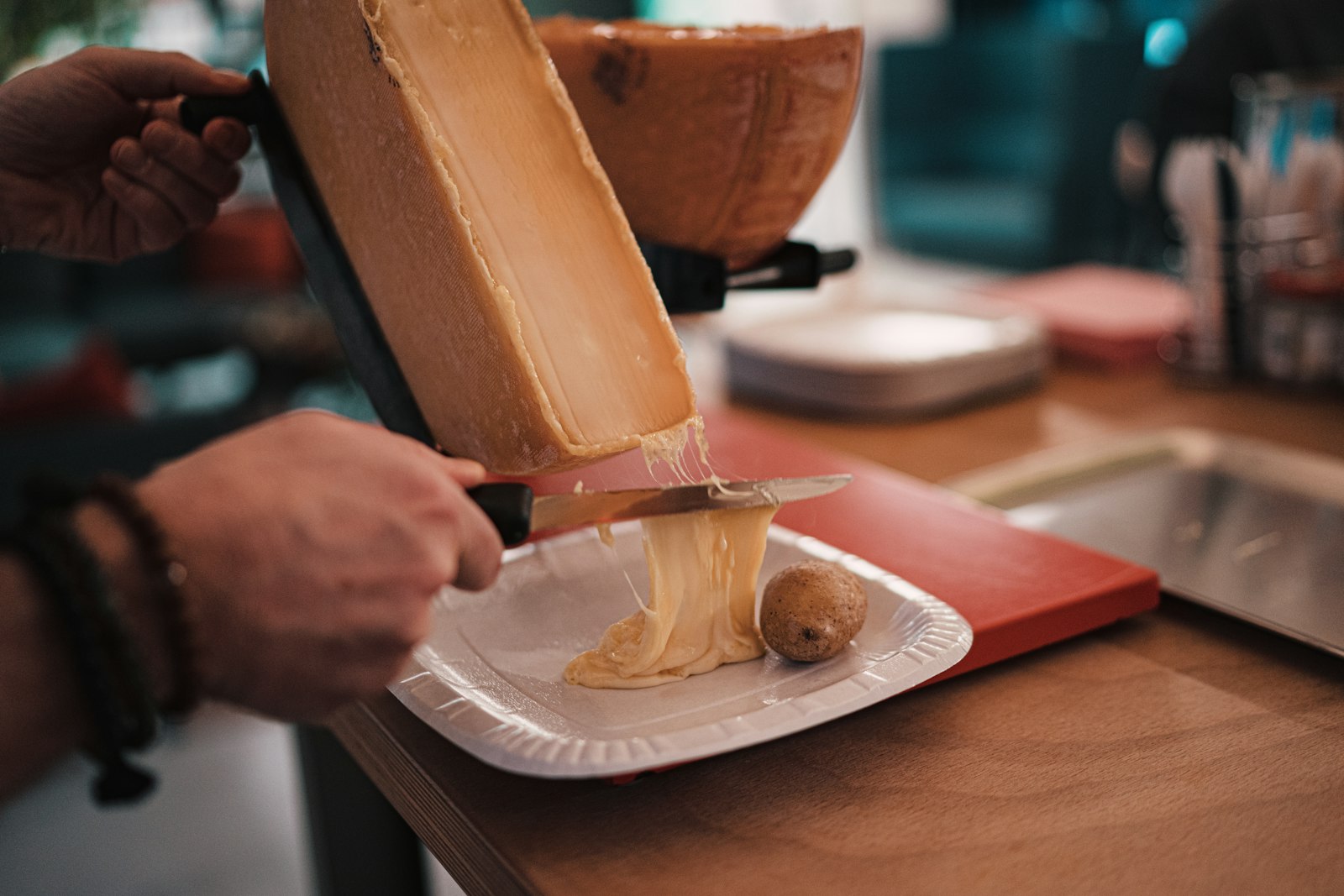 Melted raclette cheese scraped onto a plate