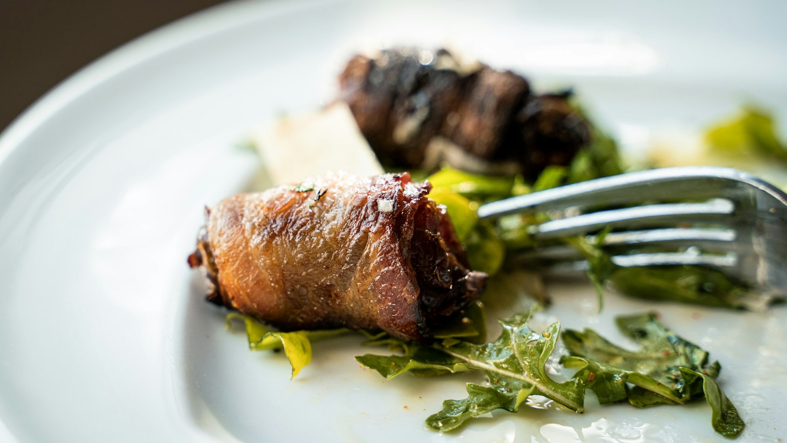Bacon wrapped dates on a plate