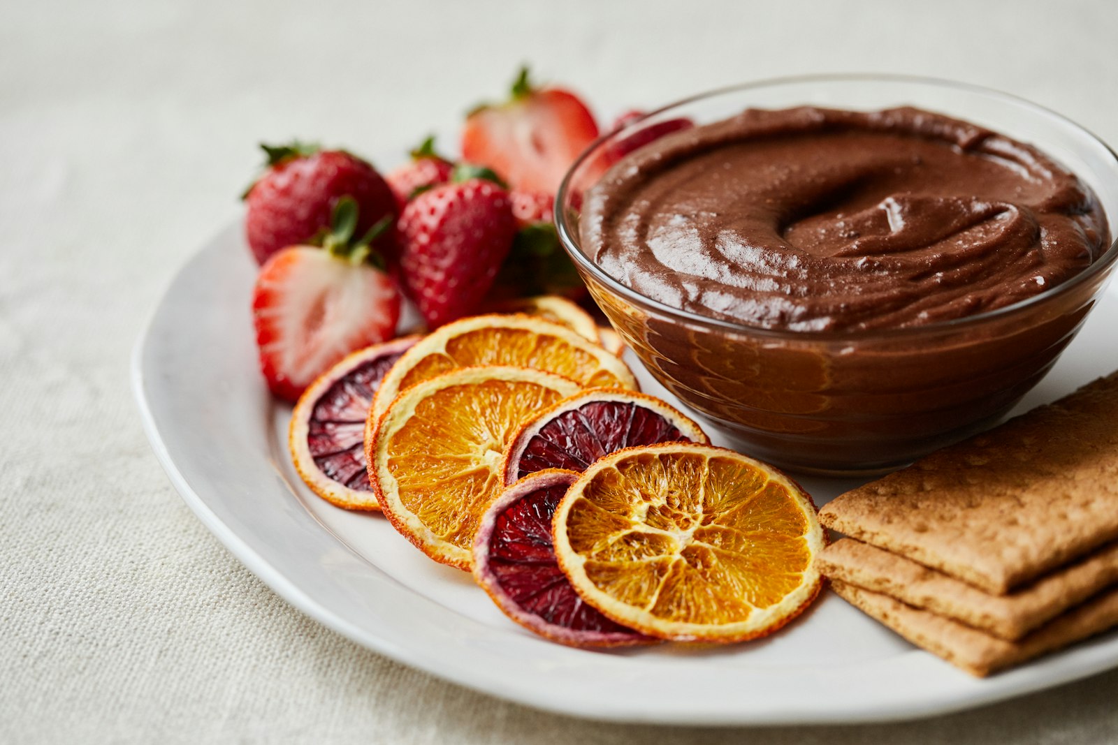 Chocolate dip with orange slices and graham crackers