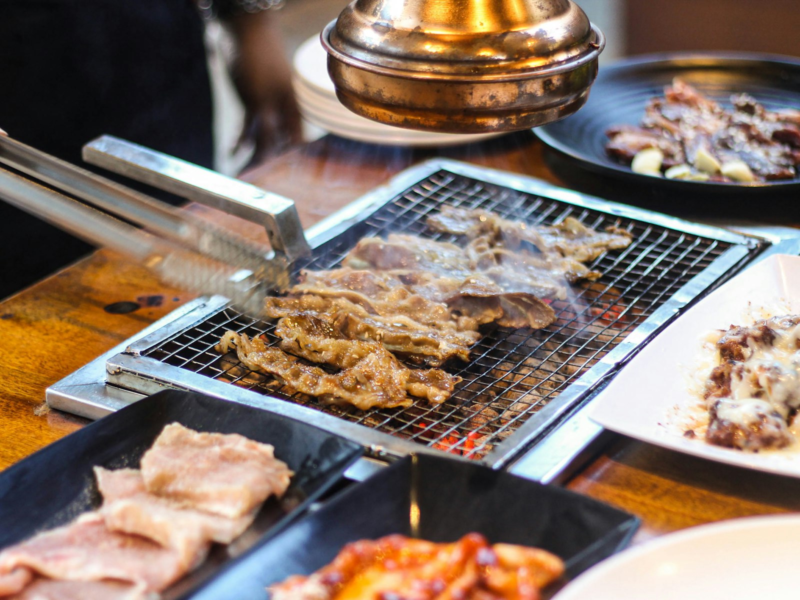 Meat sizzling on a tabletop grill