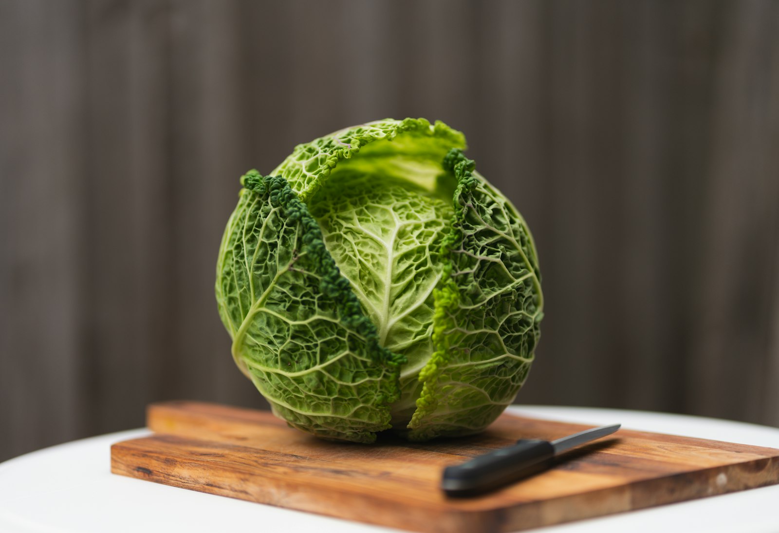 a fresh green cabbage on a wooden board