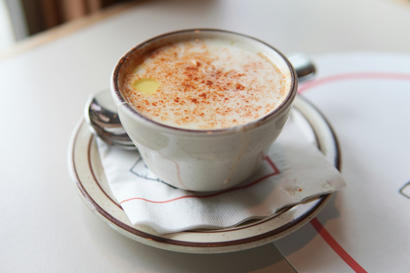 a cup of creamy New England clam chowder with paprika