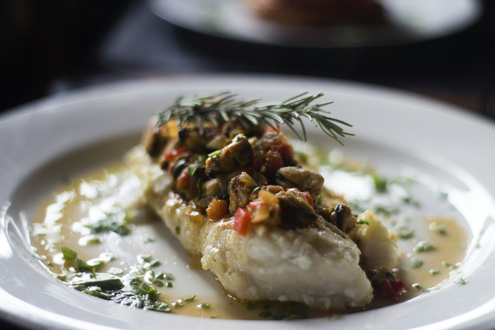 baked cod fillet with crumb topping on a plate