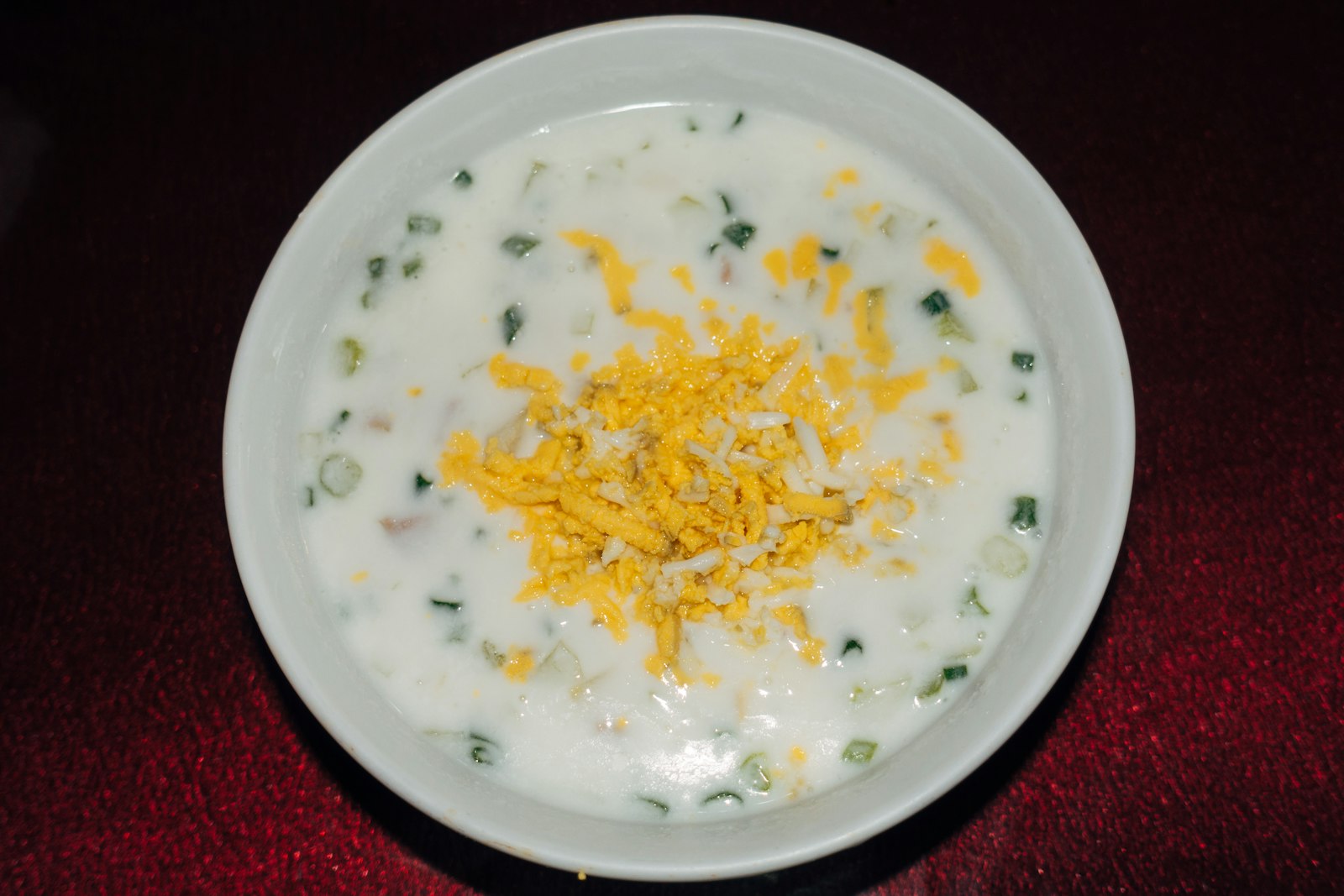 a bowl of creamy corn chowder topped with cheese