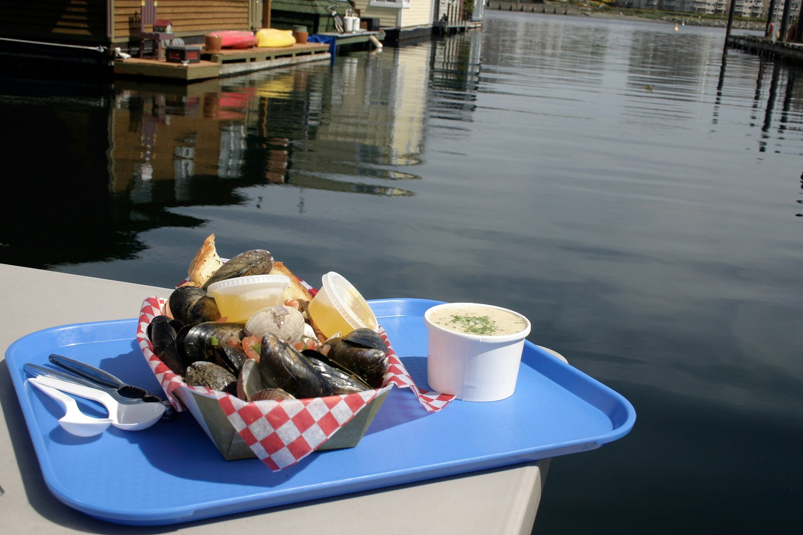 a fried seafood basket on a tray by the harbor