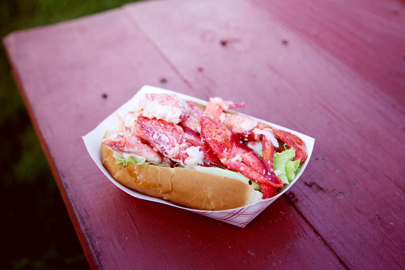 a lobster salad roll in a paper boat