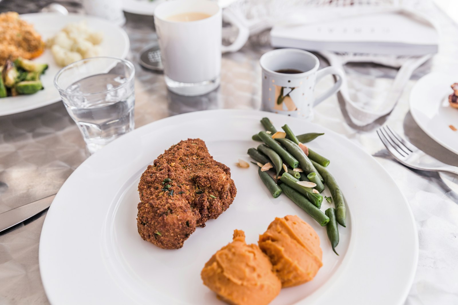sliced meatloaf with green beans and sweet potatoes on a plate
