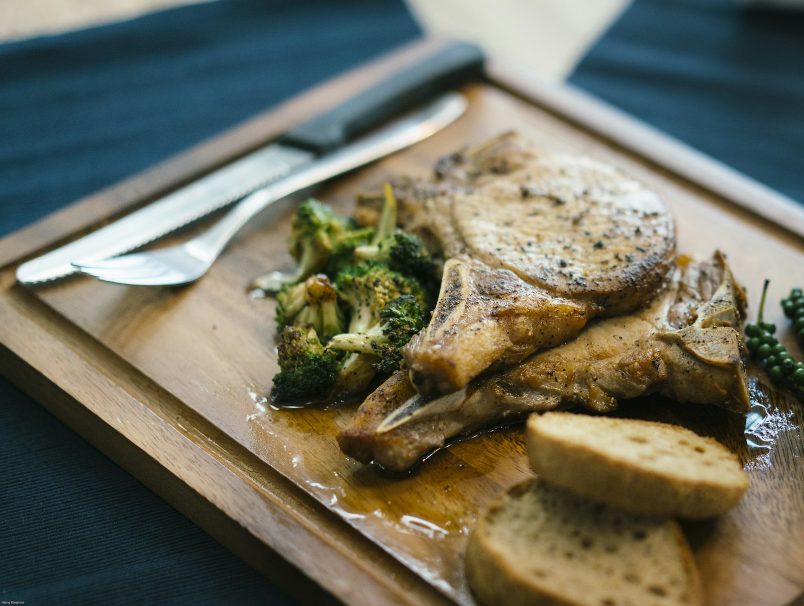 soul food pork chop with greens on a wooden board