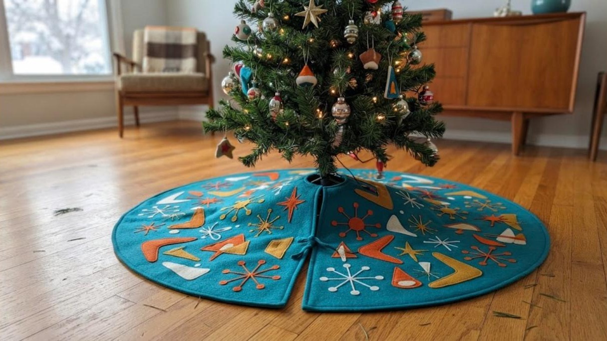 Turquoise felt tree skirt with orange and gold starbursts and boomerangs, a midcentury Christmas decor sewing project