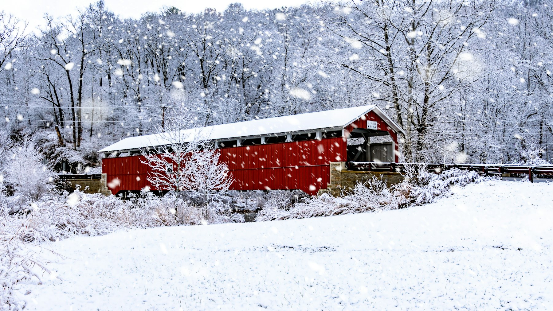 Bob Ross winter paintings subject: a red covered bridge in a snowy forest