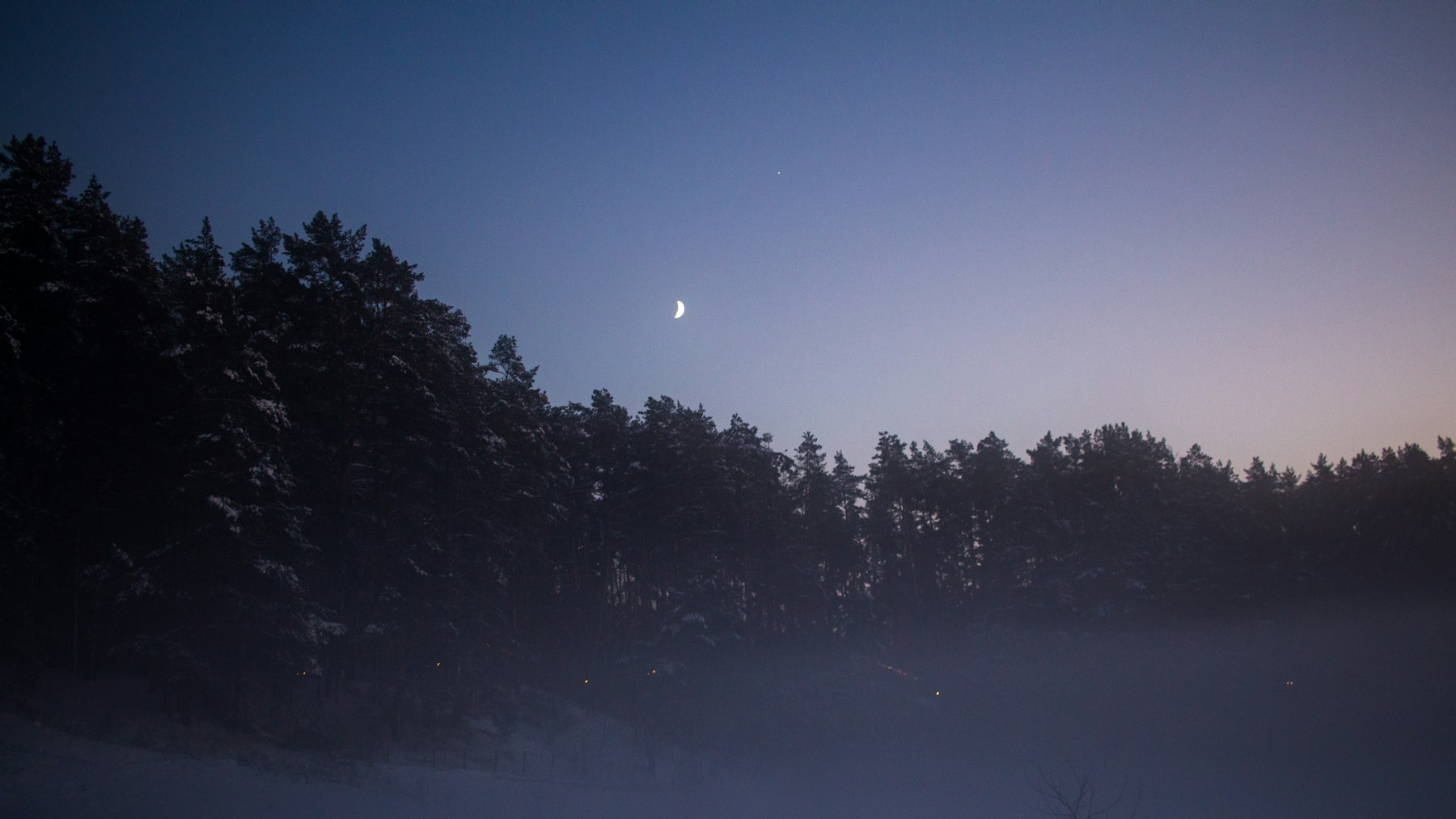 Full moon glowing over a quiet foggy winter night