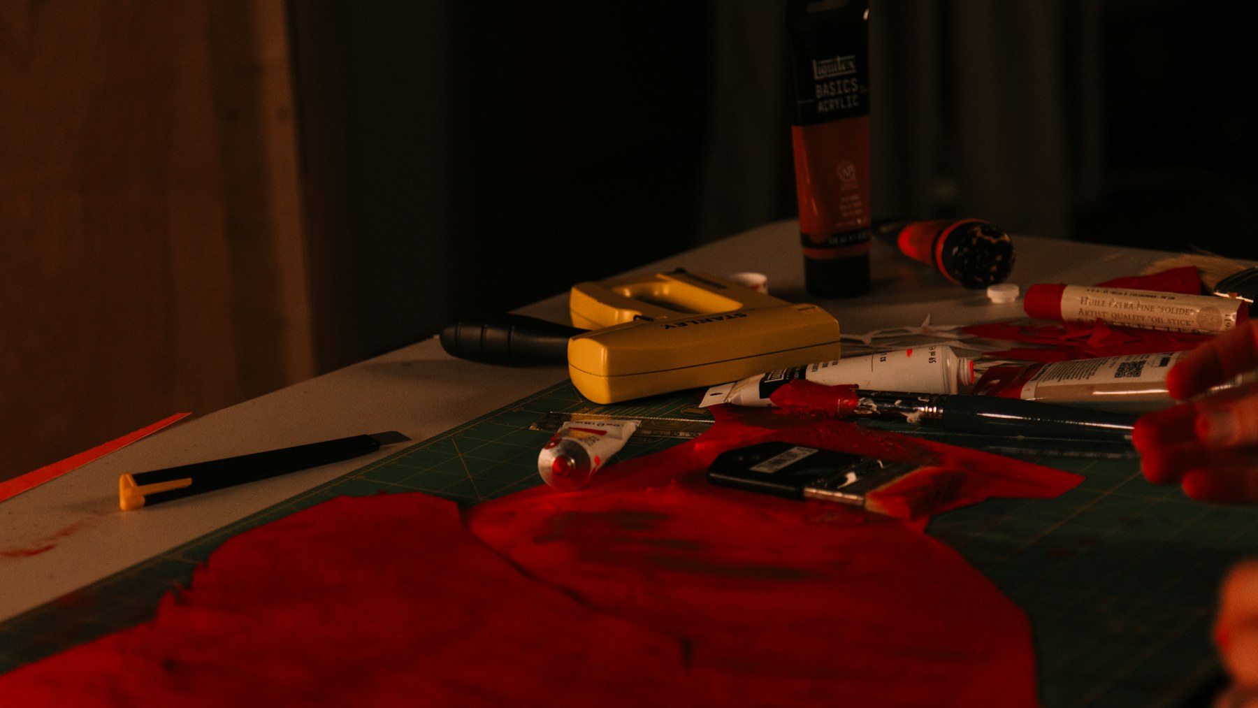 Artist table with paint and brushes ready for a painted board