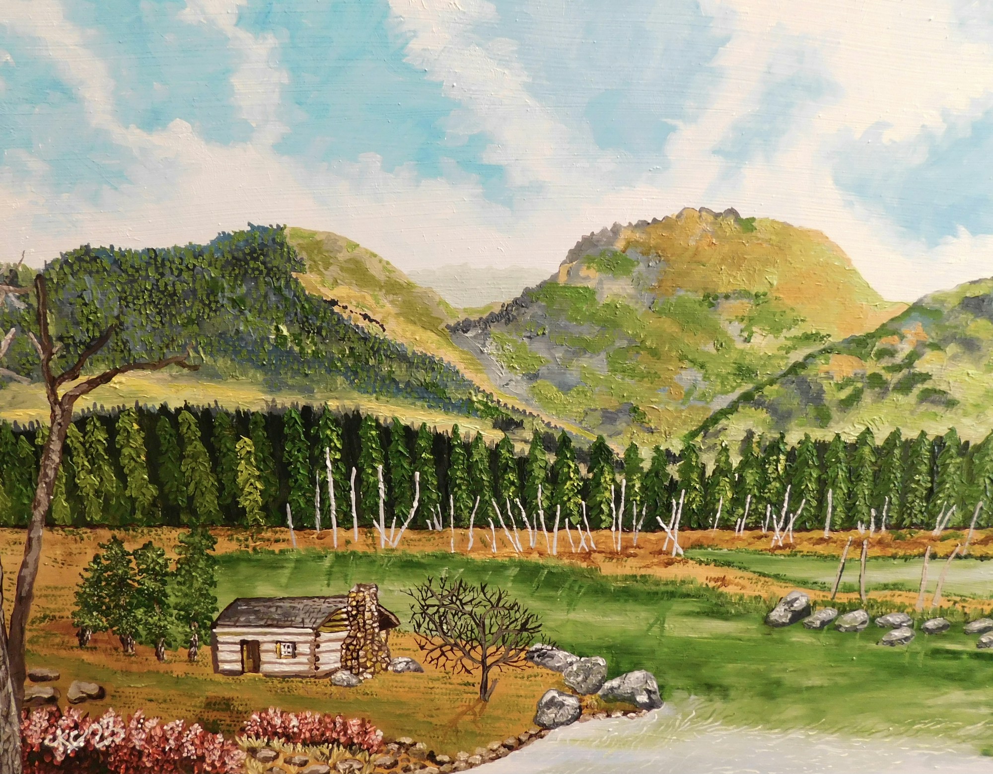Little cabin below rolling green mountains