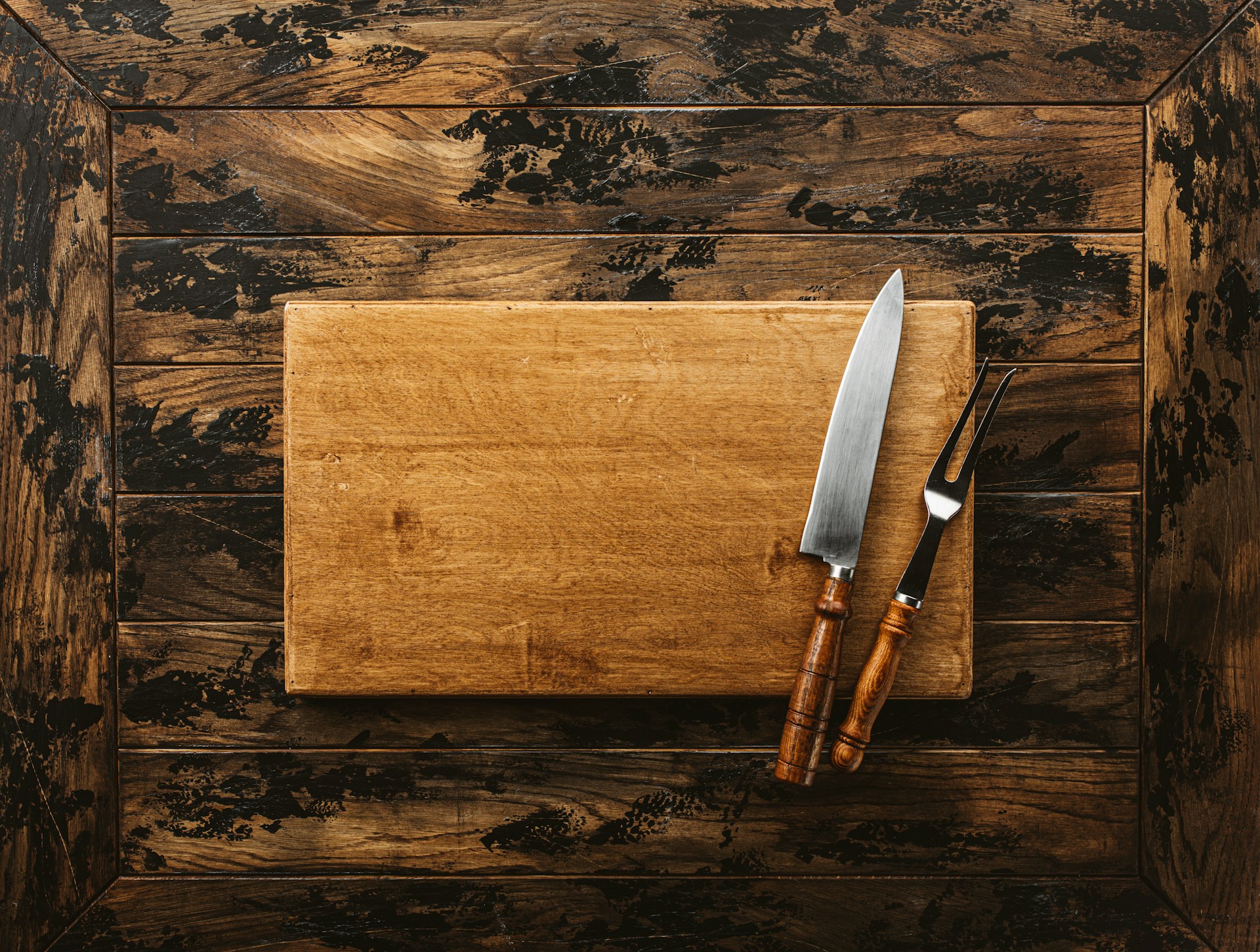 Plain wooden board on a dark table ready for a fresh coat of oil