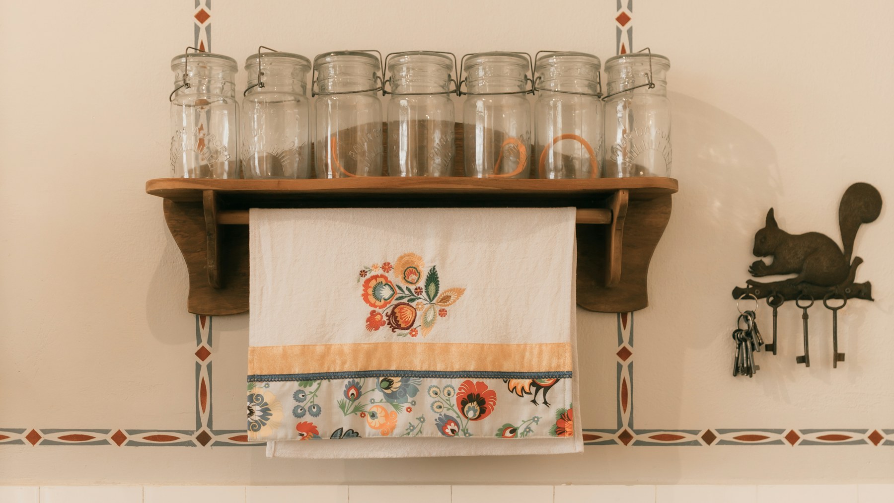 Christmas kitchen decor shelf with jars and a folded tea towel
