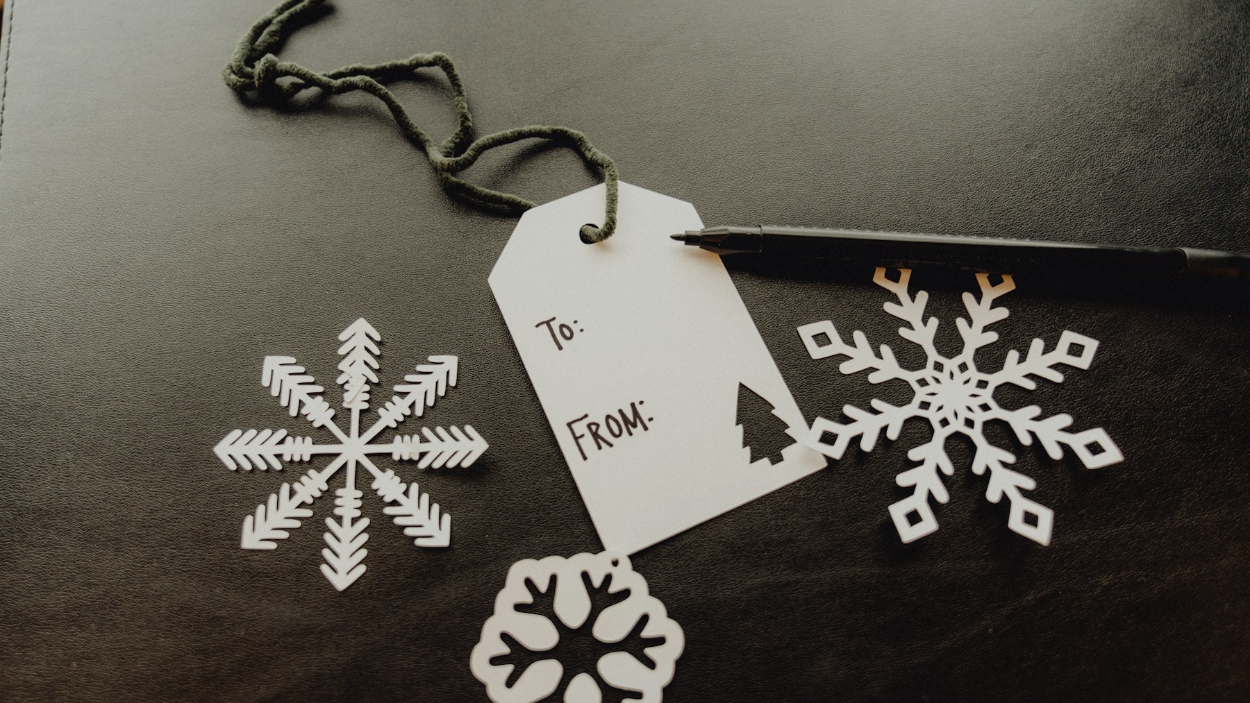 Scissors and handmade paper snowflakes for a kitchen window