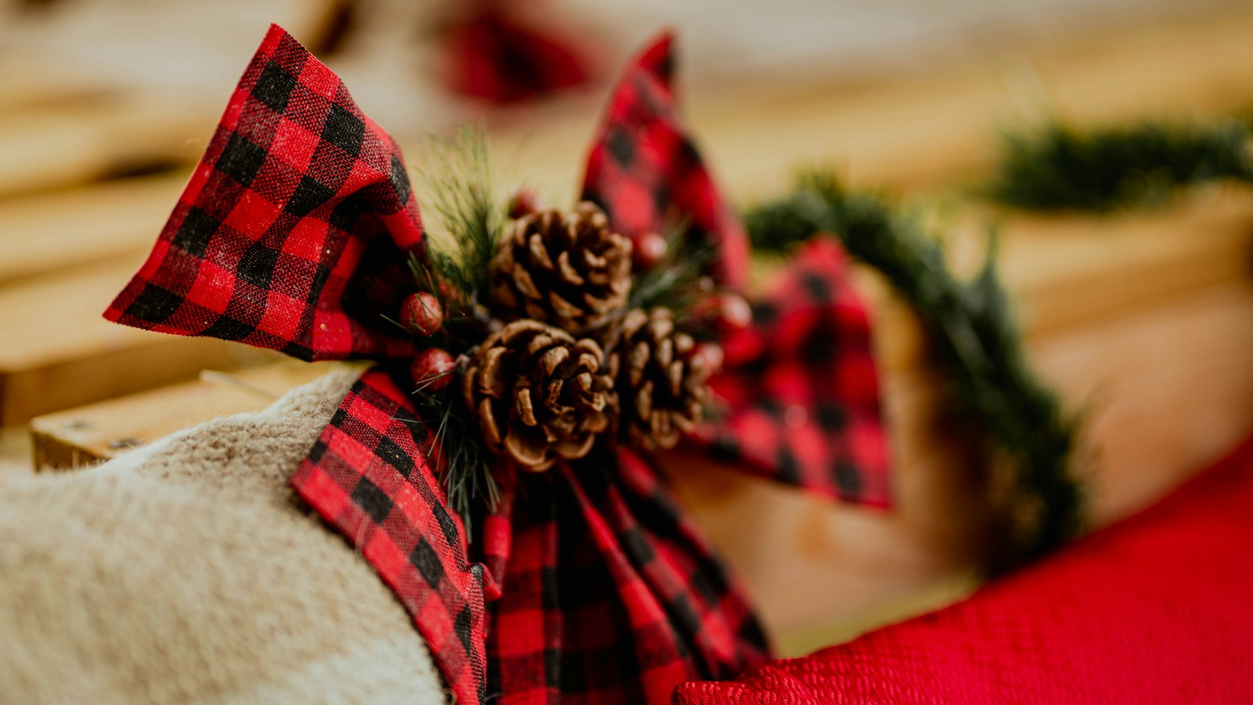 Red and black plaid ribbon bow with pine cones