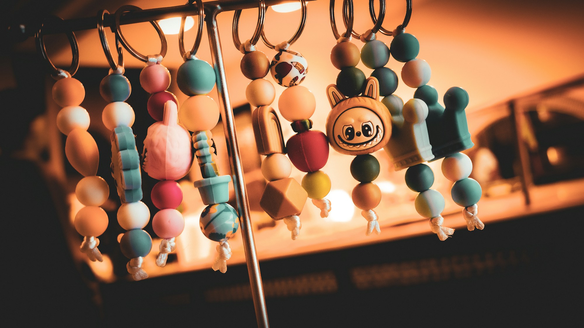 Colorful handmade beaded keychains hanging in a row