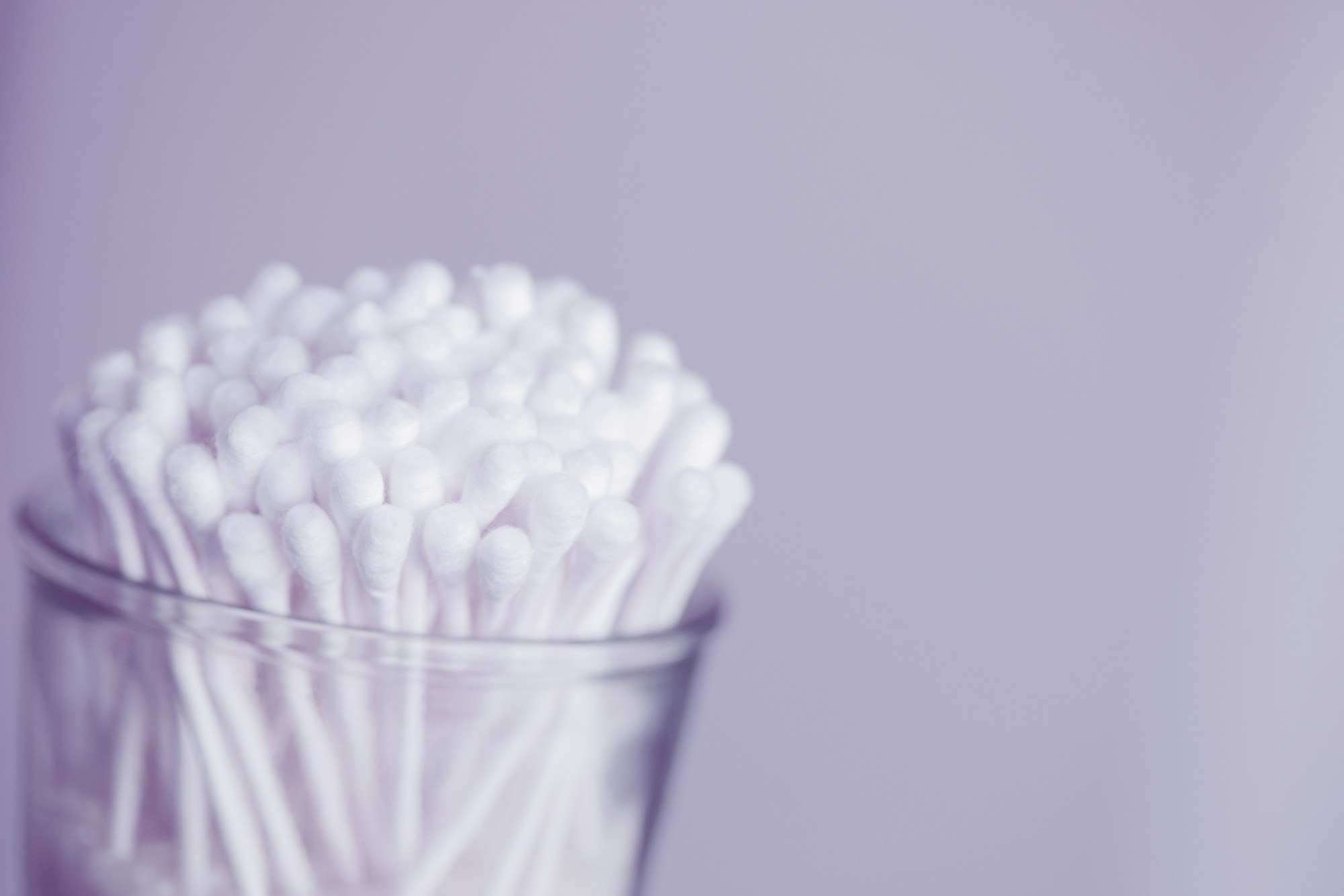 Cotton swab painting supplies: a glass full of white cotton swabs