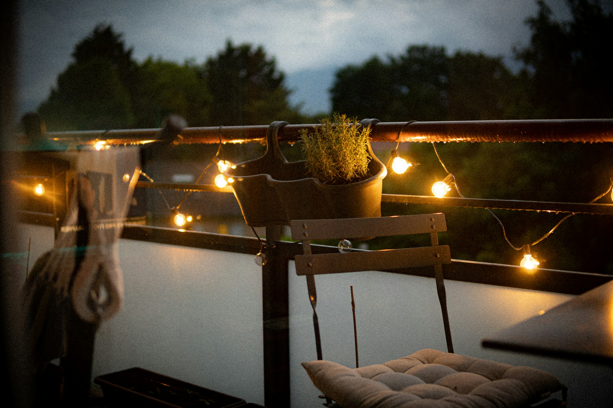 Balcony glowing with string lights in the evening