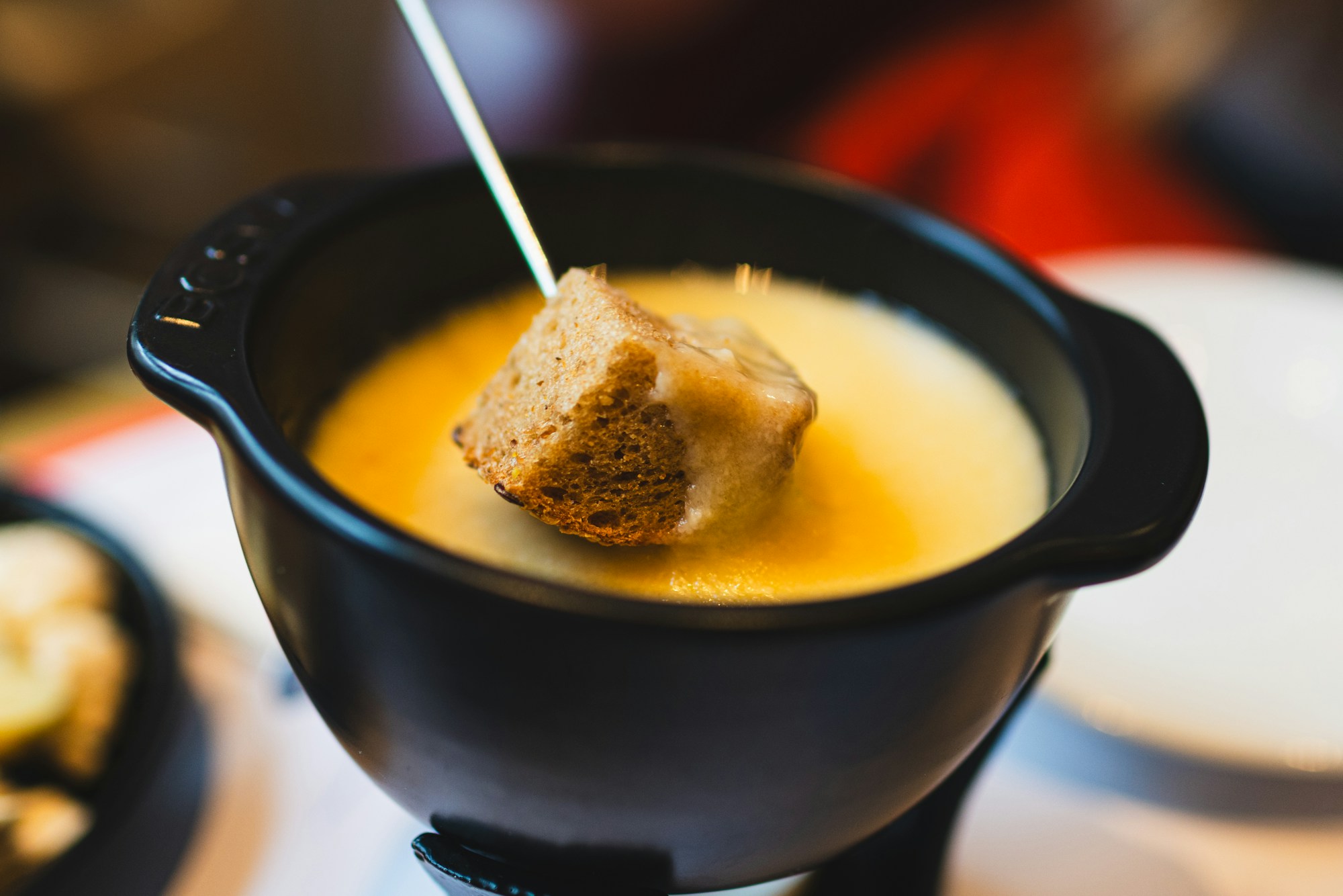 Bread dipped into a pot of melted cheese fondue