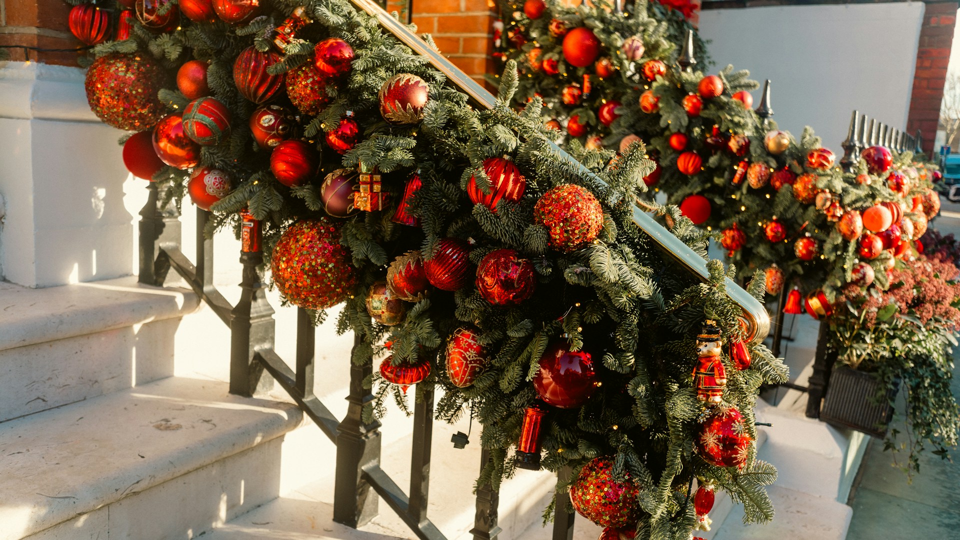 Garland with red ornaments wired along a staircase