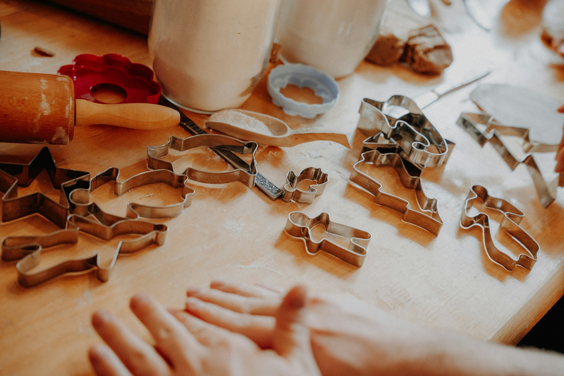 Cookie cutters and a rolling pin on a wooden table