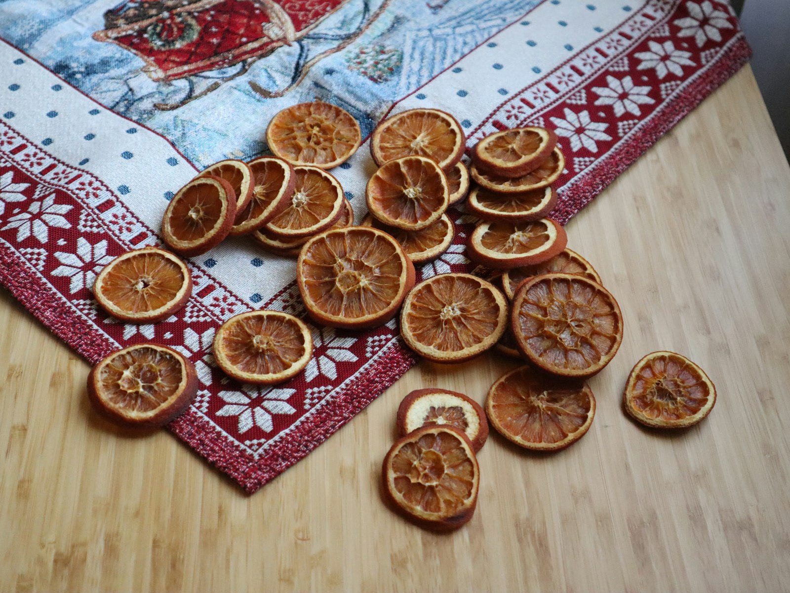 A stack of finished dried orange slices on a table ready to store