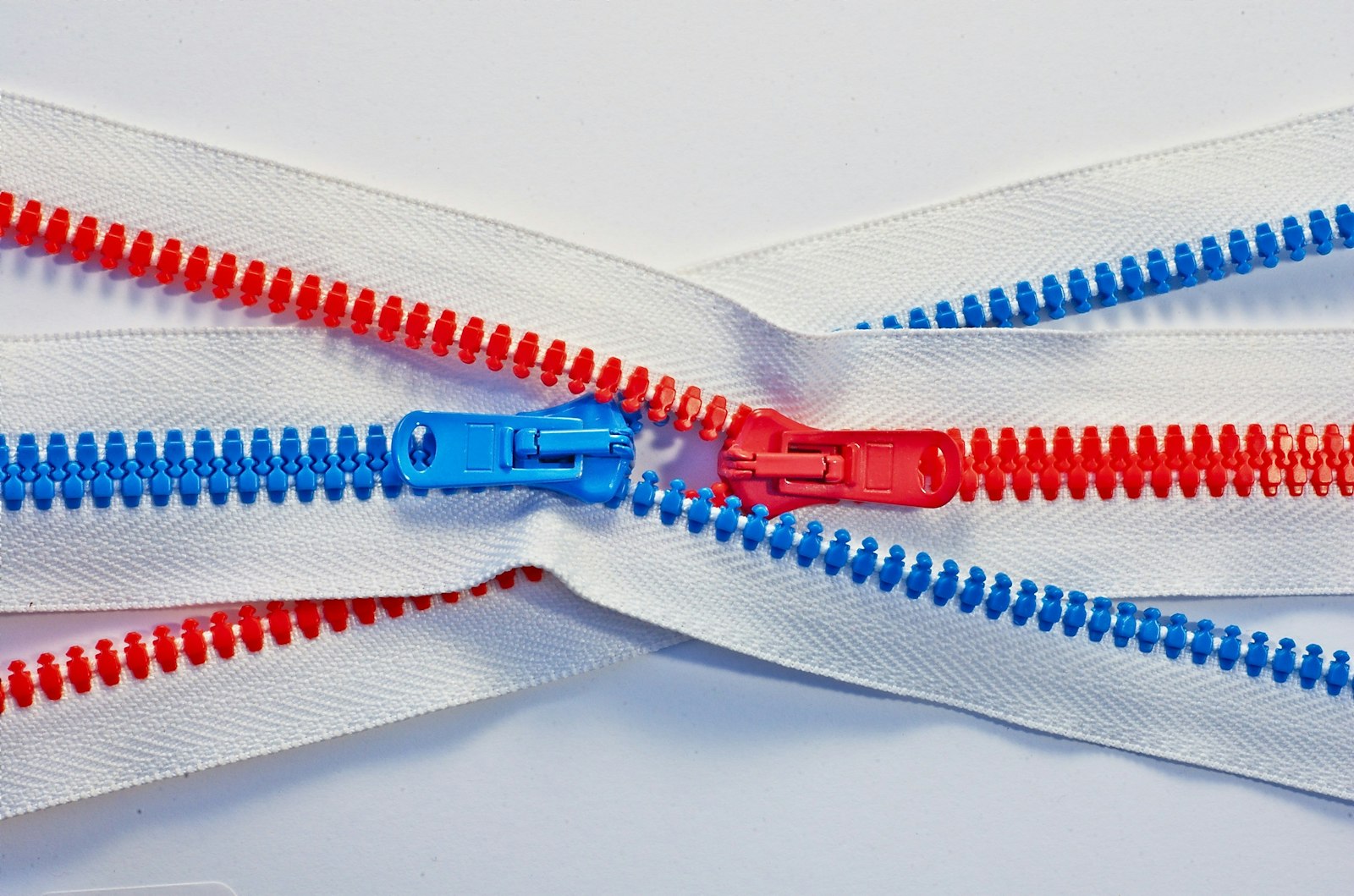 Close-up of red and blue zippers ready for a zipper pull fix
