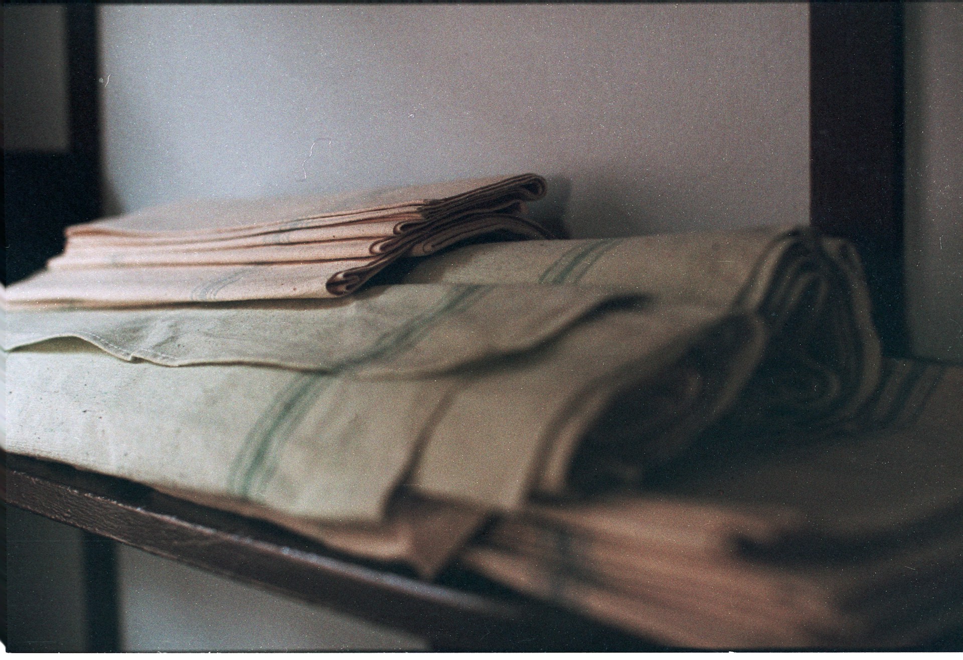 Clean folded table linens stored on a shelf