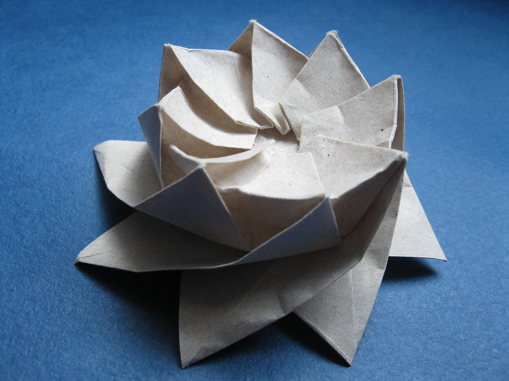 Folded paper lotus flower with layered pointed petals
