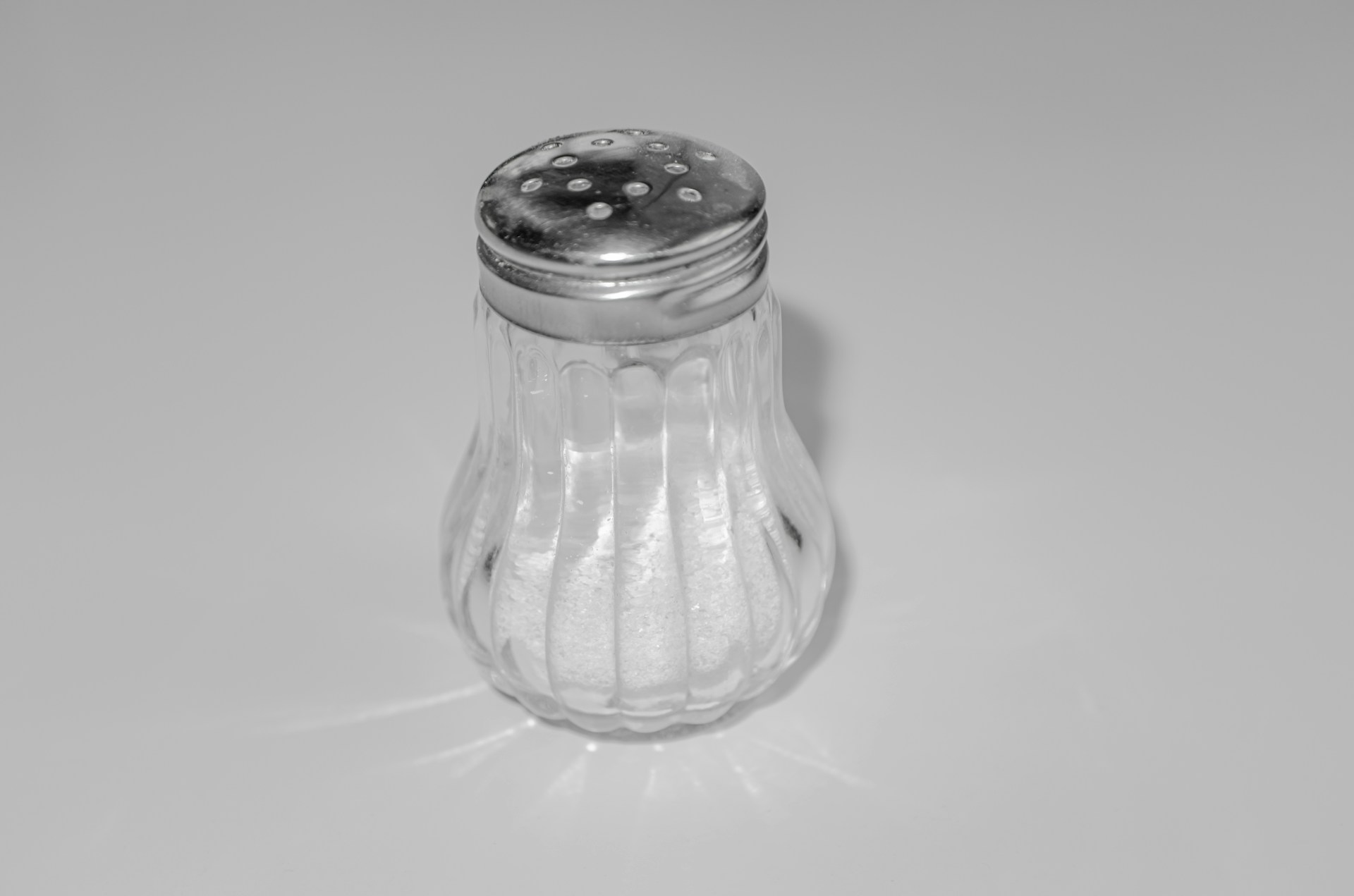 Glass salt shaker with a metal lid