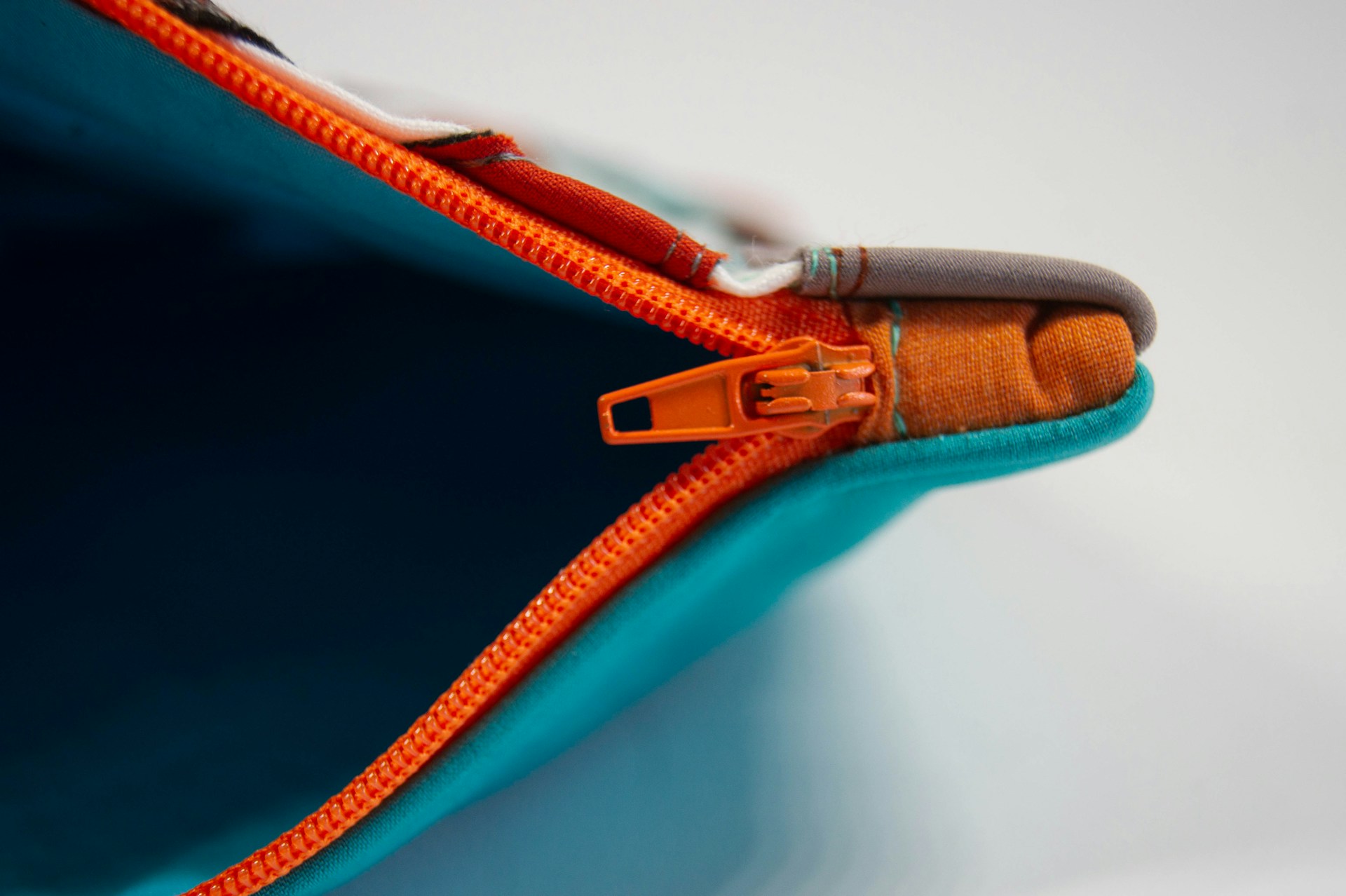Old school household hacks orange zipper on a fabric pouch
