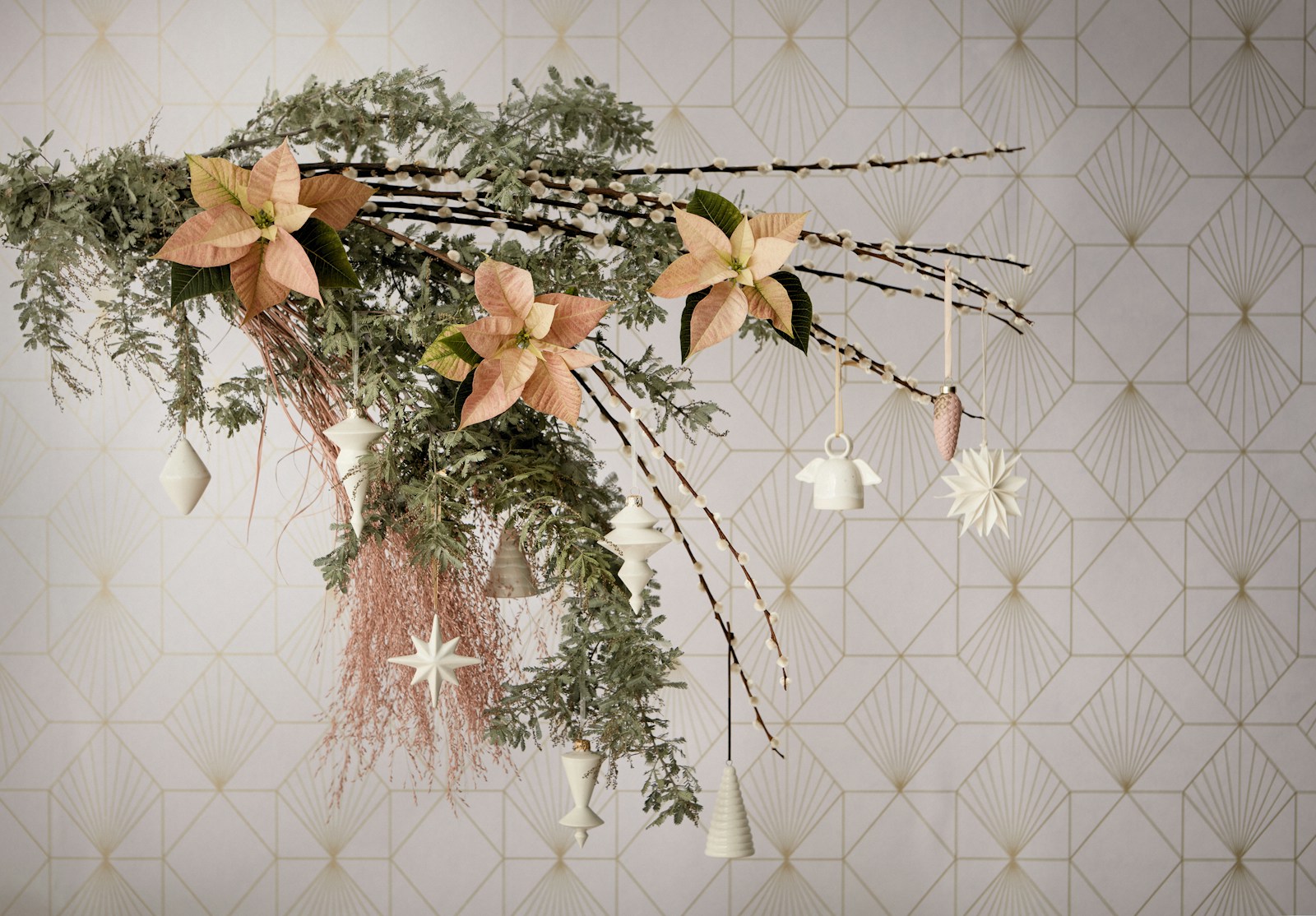 A hanging spray of greenery and branches with peach poinsettia blooms and small ornaments