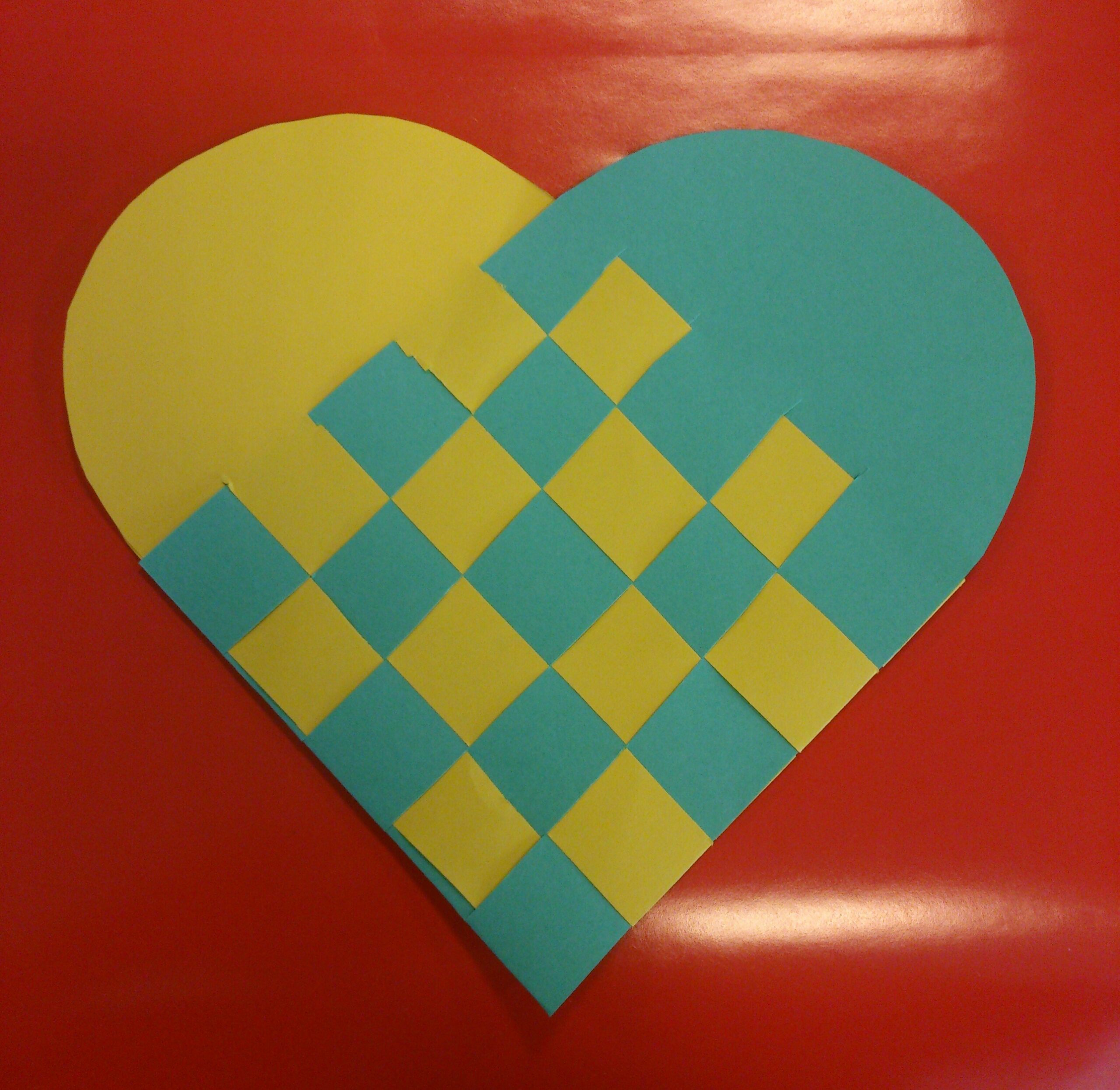 Copy of the Hans Christian Andersen woven heart made from yellow and teal paper on red