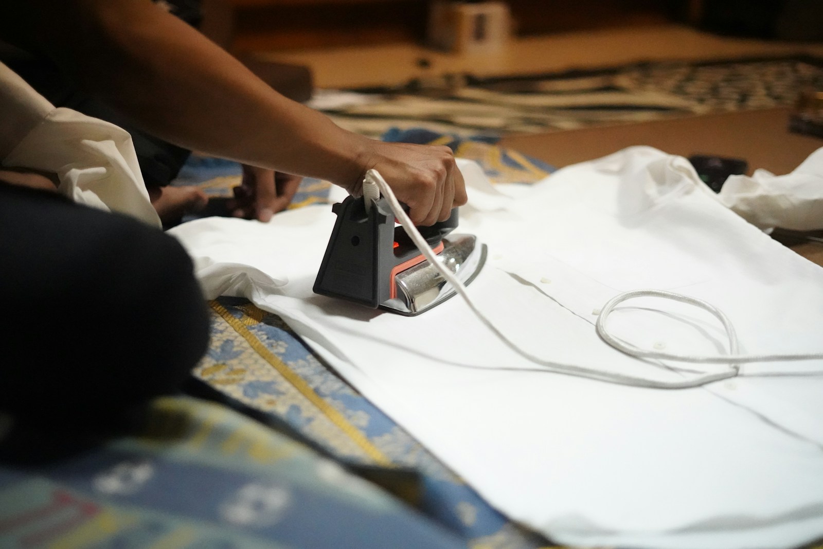 Ironing white cloth smooth on an ironing board