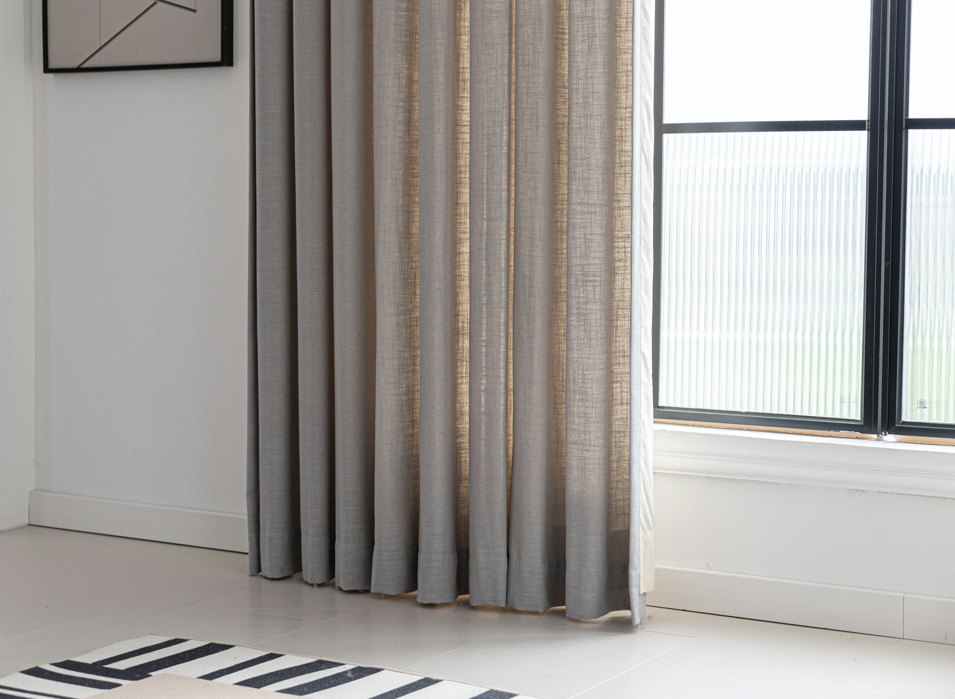 Long curtains framing a window in a bright, airy room