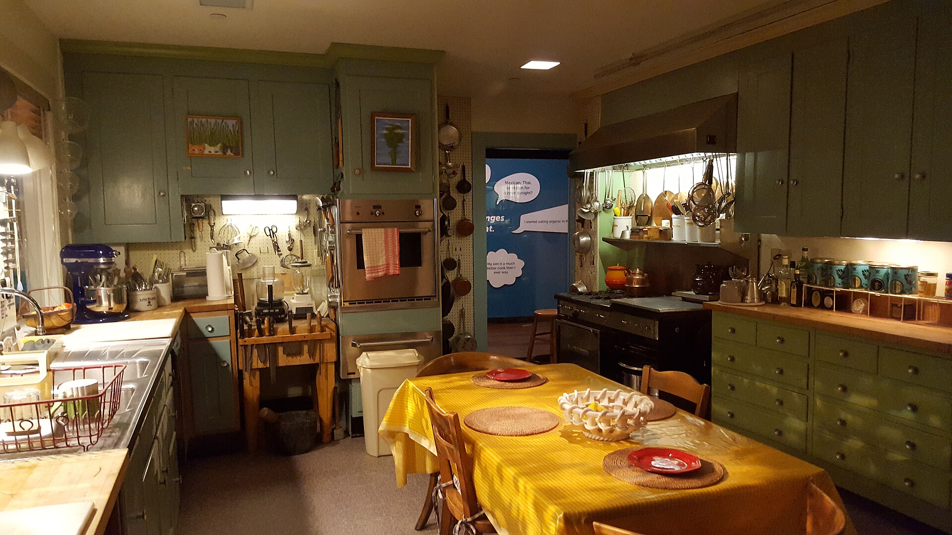 Julia Child Kitchen exhibit with a big table dressed in a yellow cloth in the middle of the room