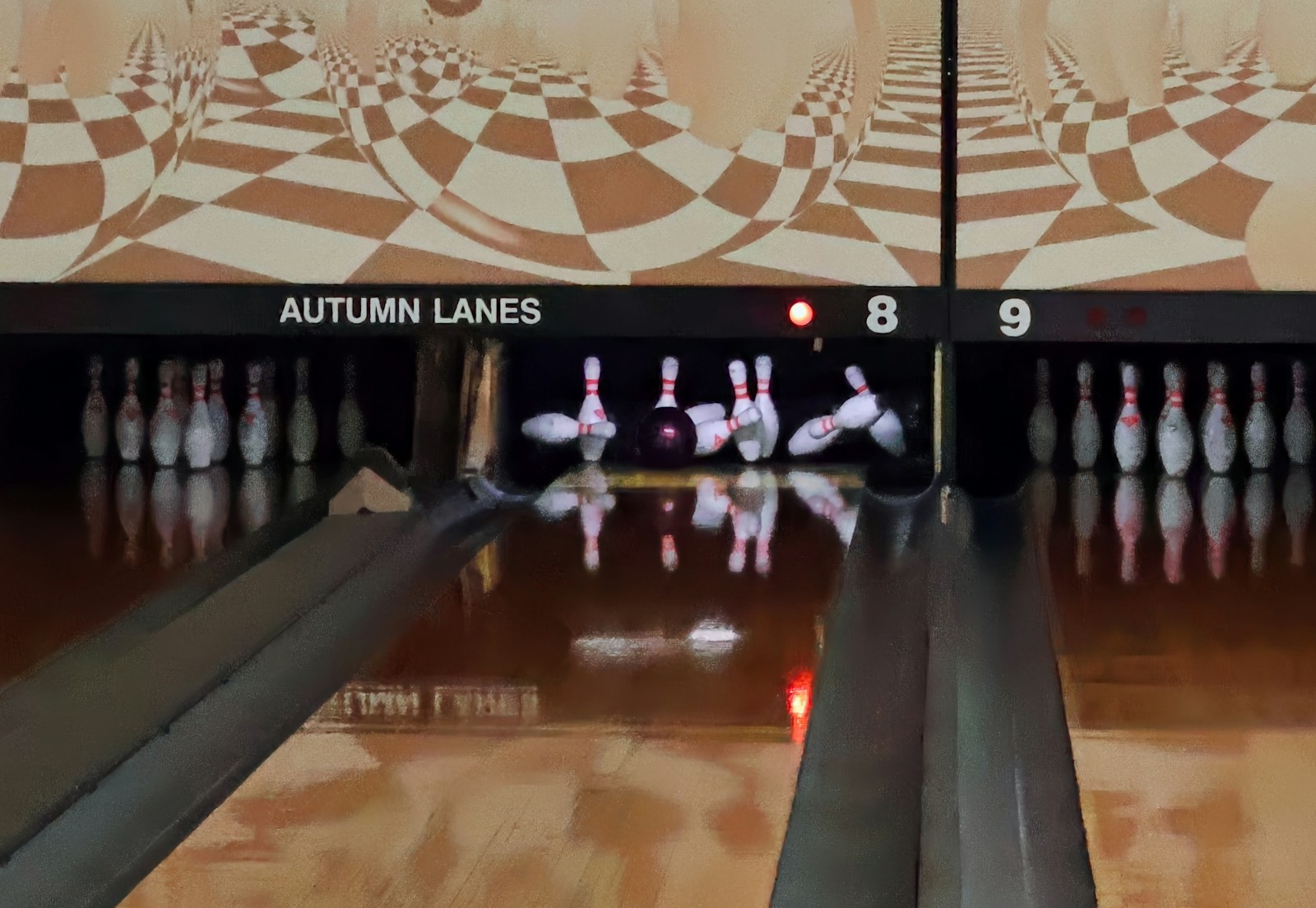 White bowling pins standing at the end of a bowling lane