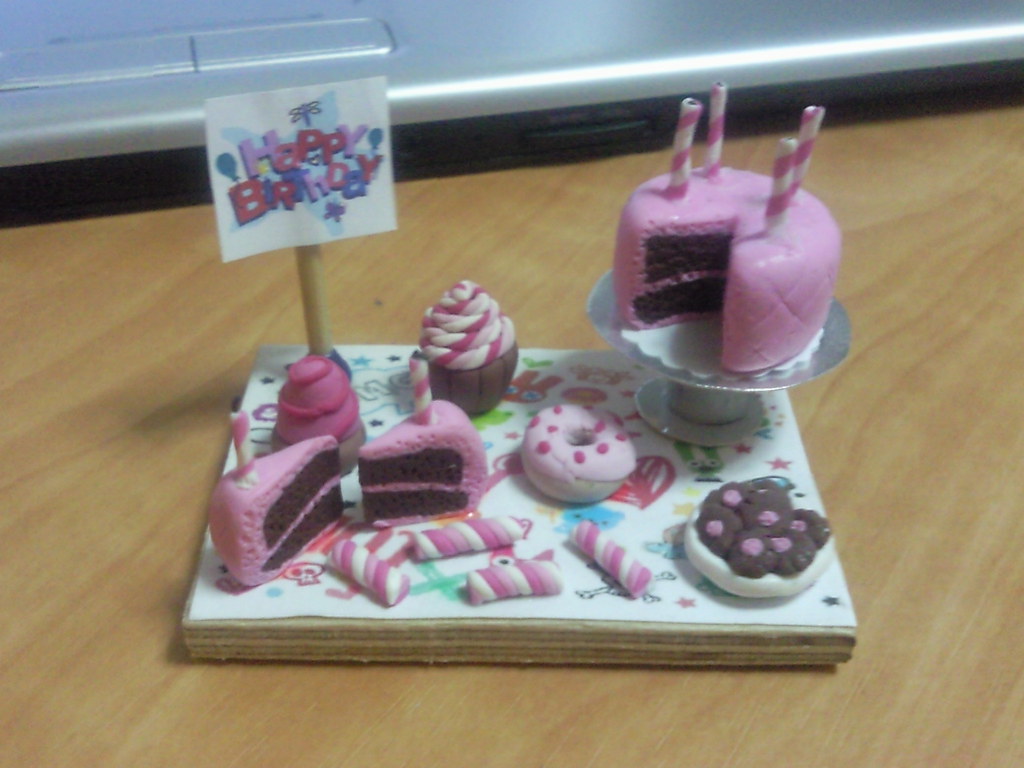 Miniature clay cake slices and tiny desserts on a small table