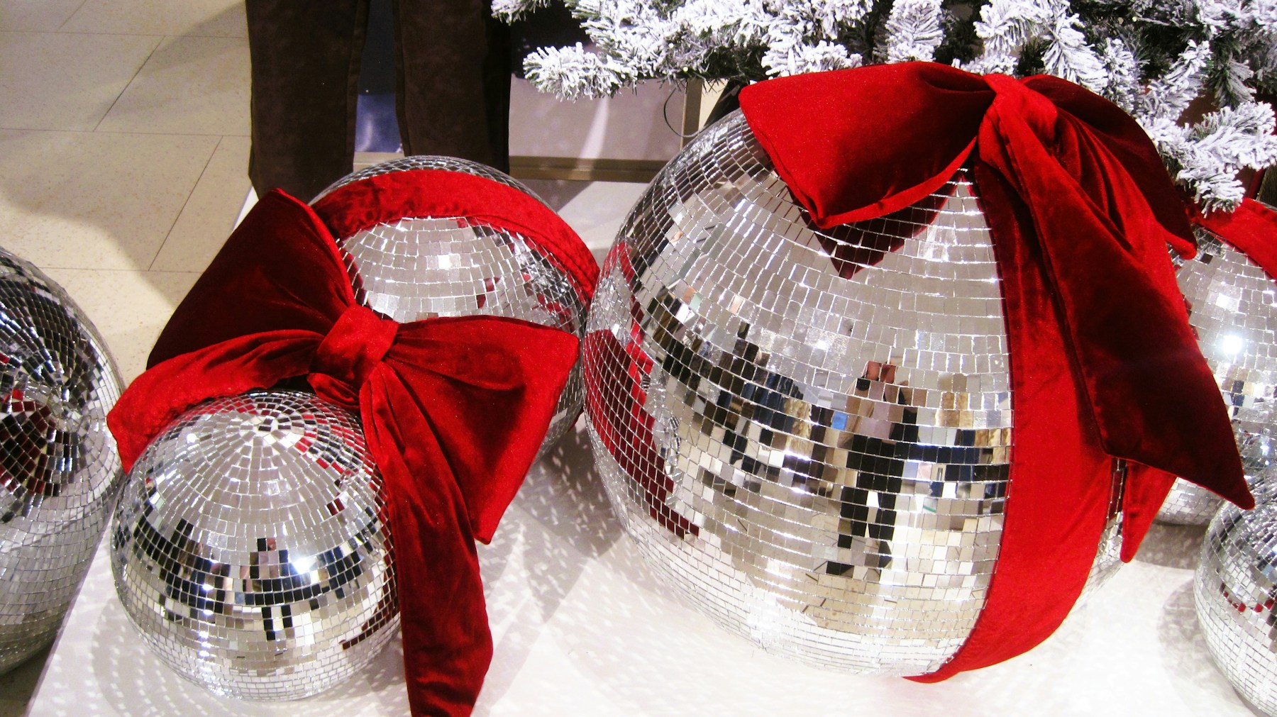 Sparkly mirror ball ornaments with red bows
