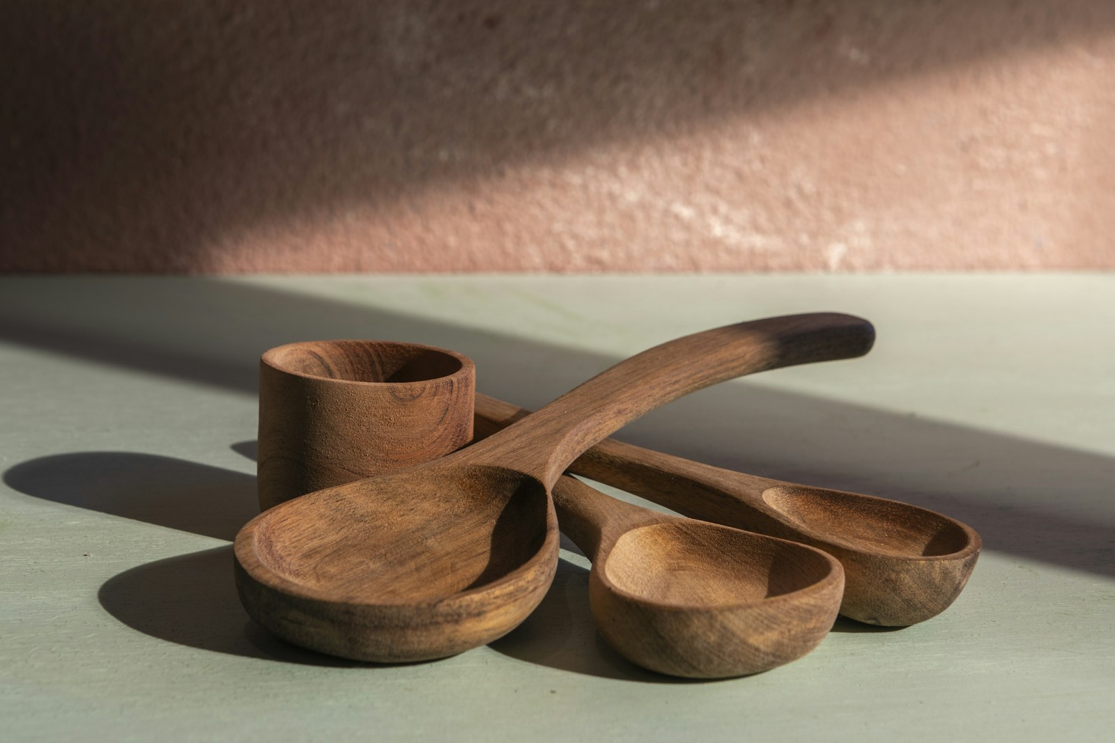 Plain wooden spoons and a cup ready for painted handles