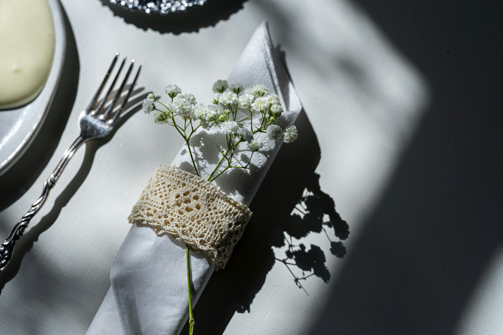 Patterned paper napkin tucked under a fork on a table