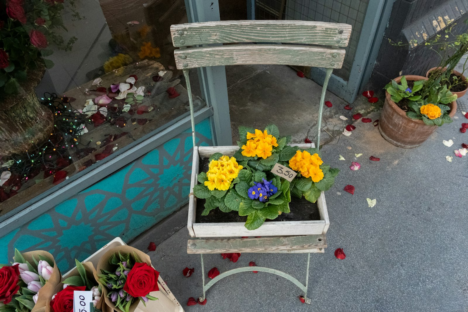 Flower planter box sitting on an old metal chair