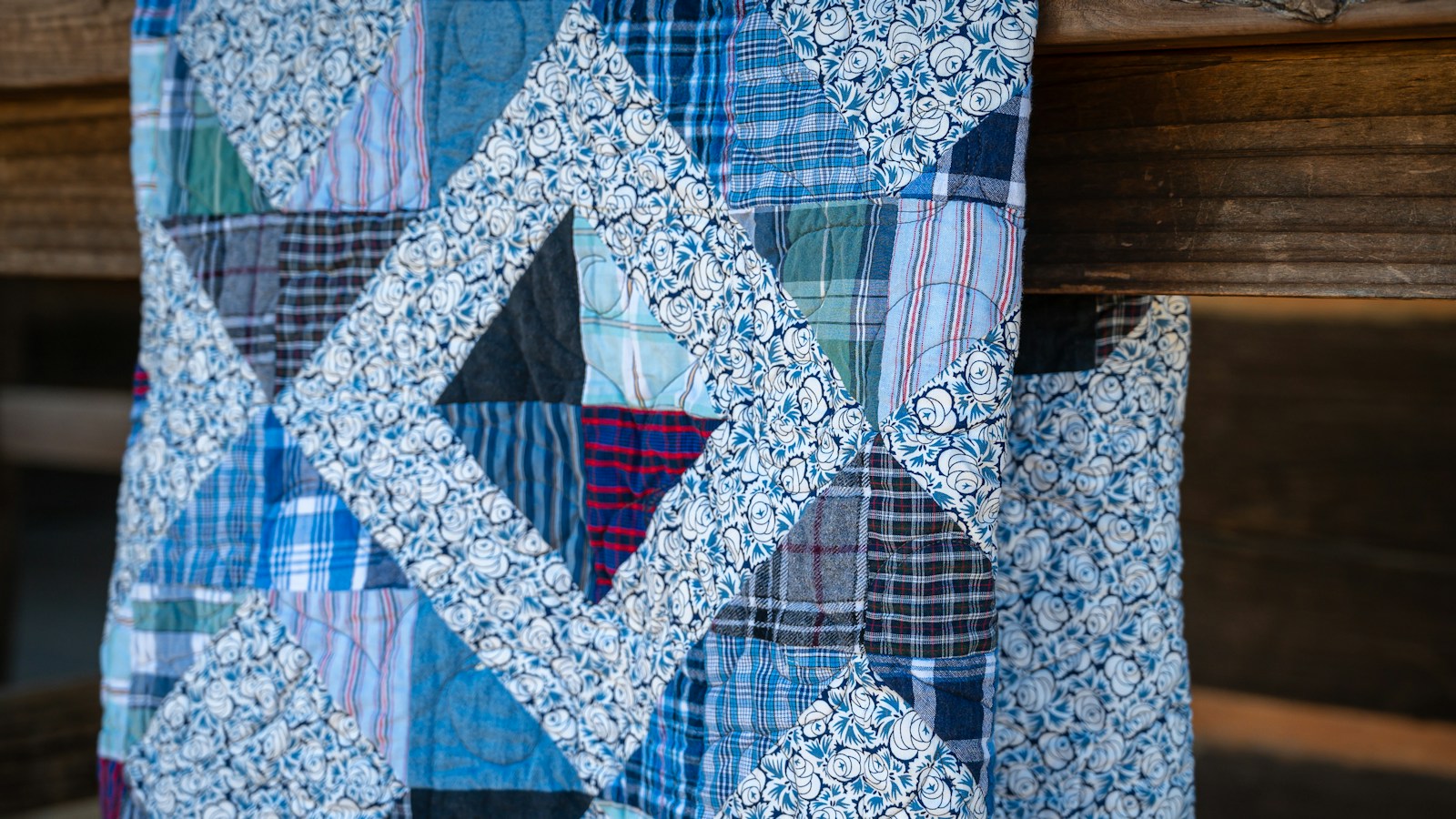 Patchwork memory quilt sewn from old plaid and print shirts
