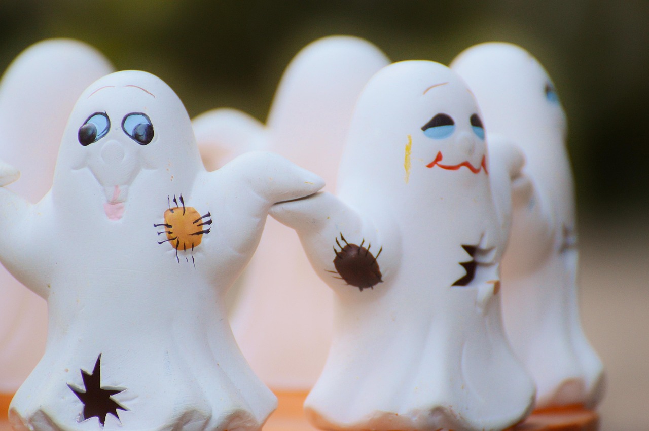 Group of white painted ghost figures with silly faces