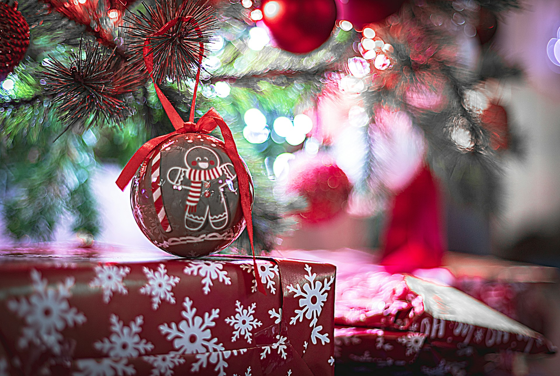 Brown ornament painted with a white gingerbread man hanging on a tree